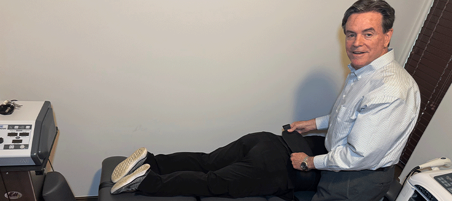 Dr Keith Ryan providing spinal decompression to patient on a spinal decompression table in Tulsa, OK